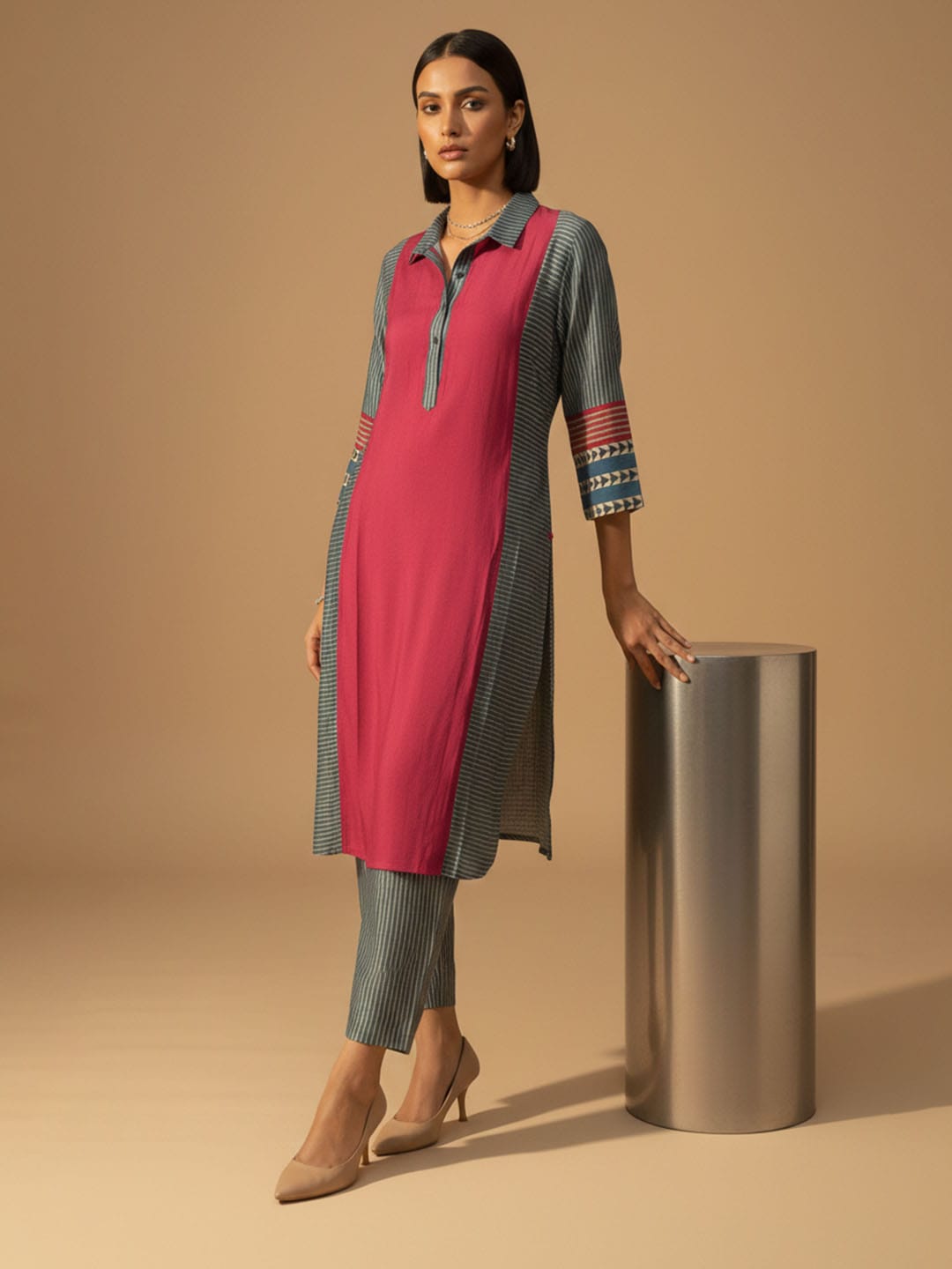 Classic red printed kurta with mandarin neckline and ankle-length elasticated trousers for effortless charm.