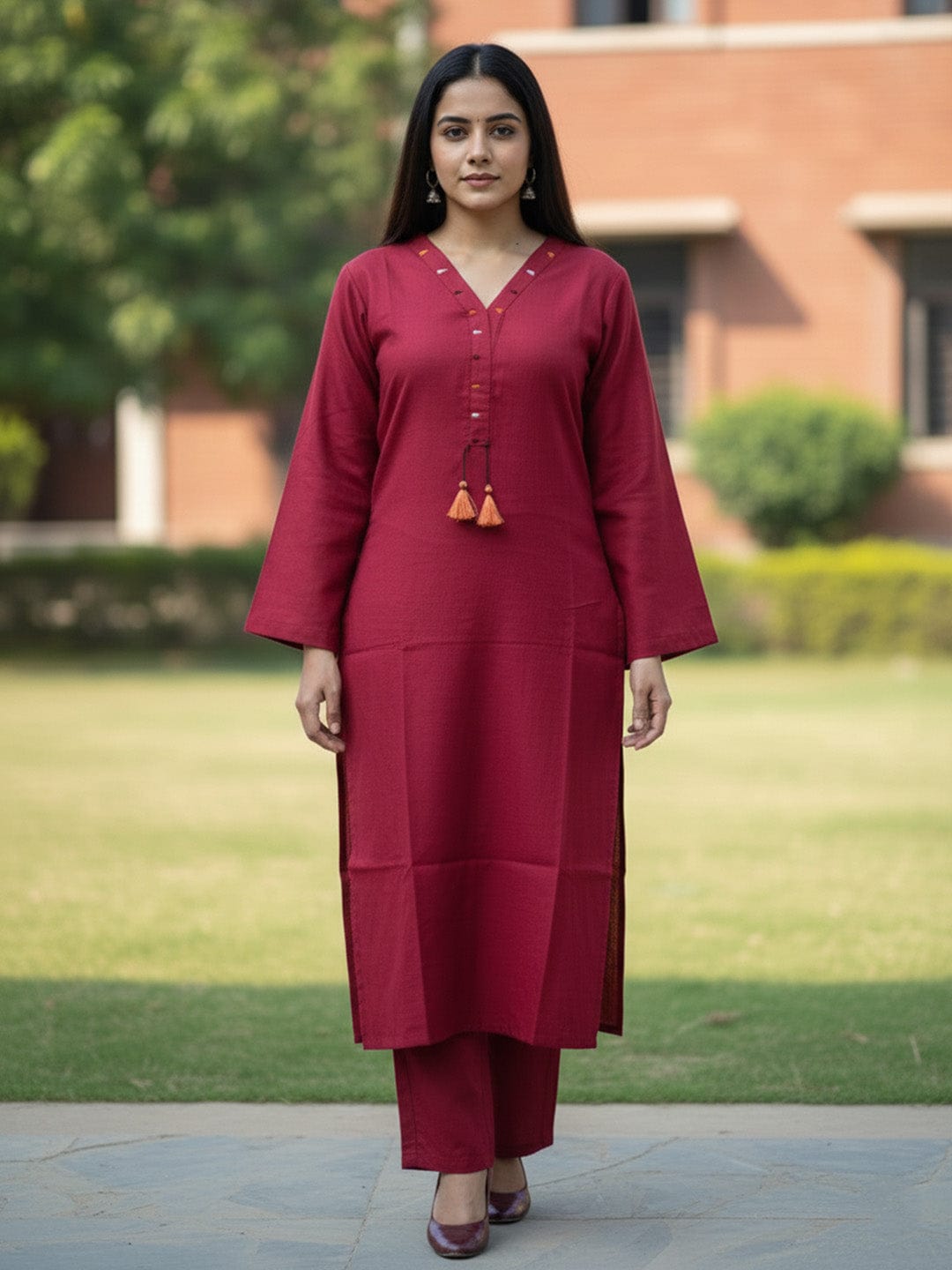Solid straight-fit kurta with graceful embroidery and a round neckline, paired with full-length elasticated straight trousers.