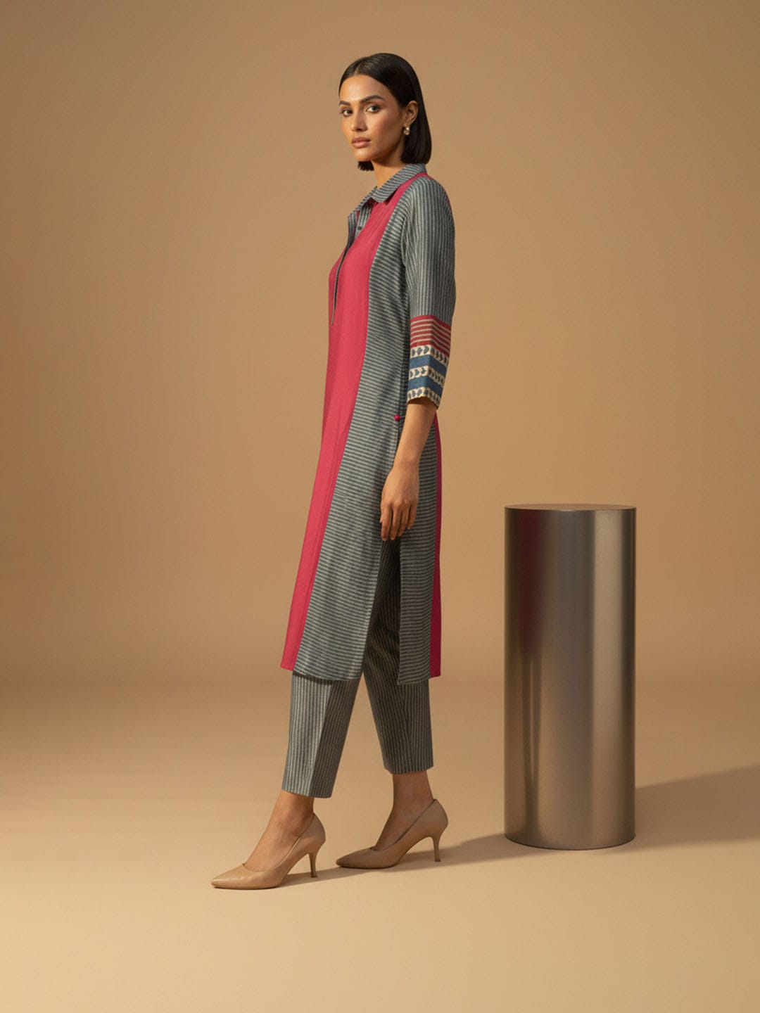 Classic red printed kurta with mandarin neckline and ankle-length elasticated trousers for effortless charm.