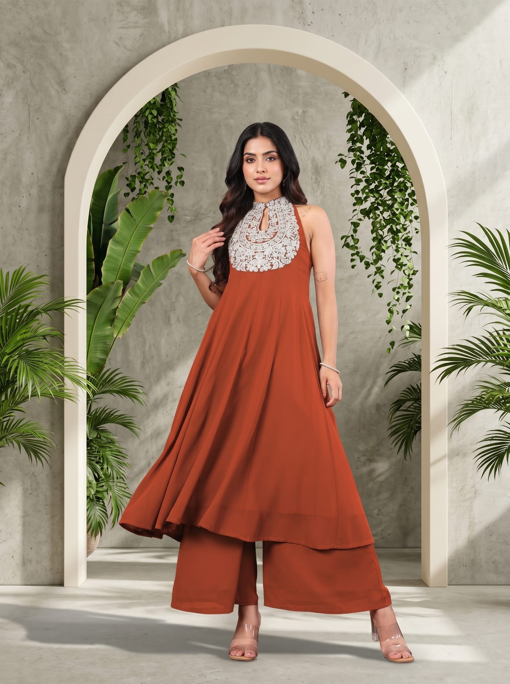 The Kurti Collection Women Rust Yoke Embroidered Sleeveless Flared Kurta With Trousers.