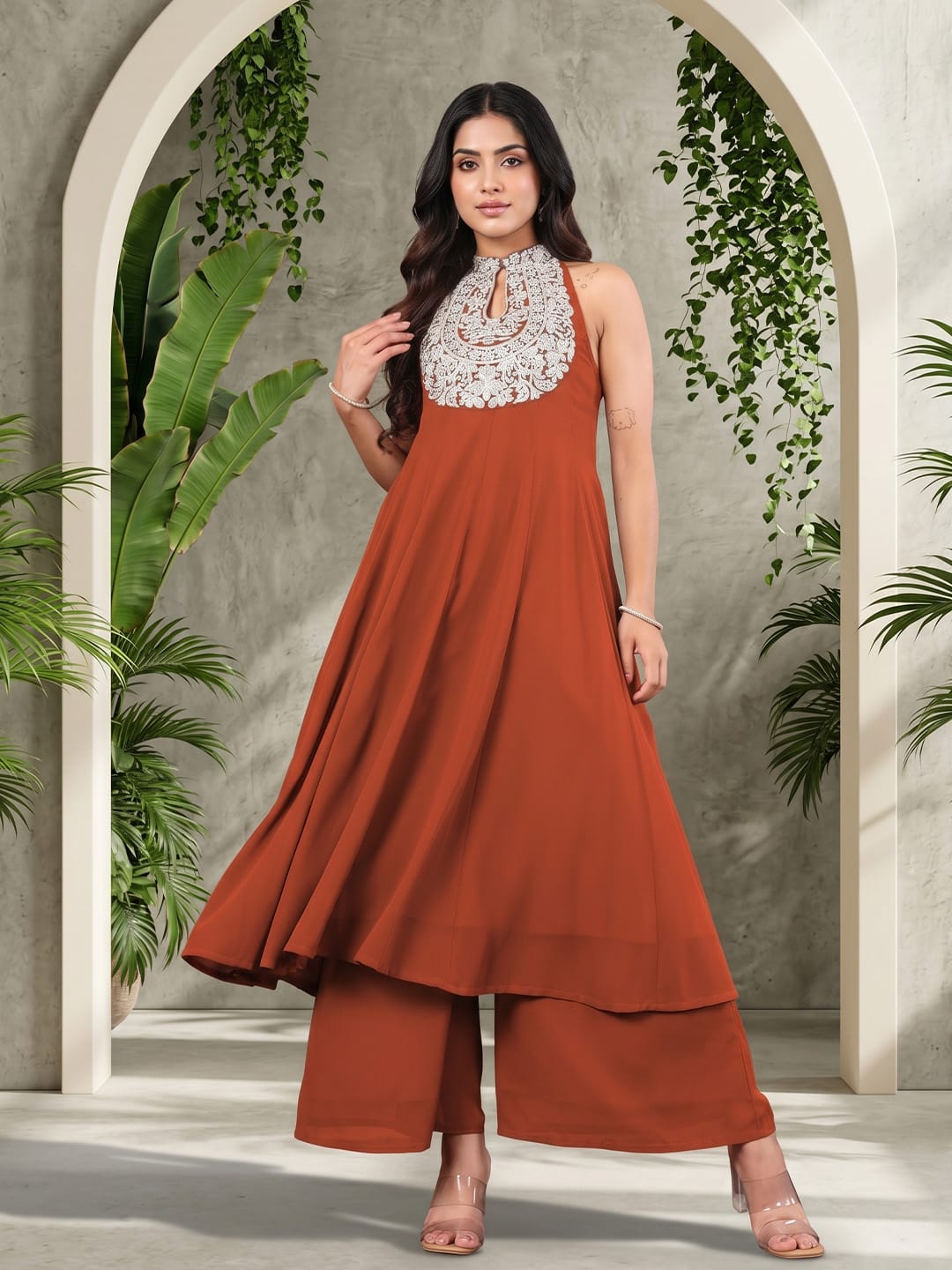 The Kurti Collection Women Rust Yoke Embroidered Sleeveless Flared Kurta With Trousers.