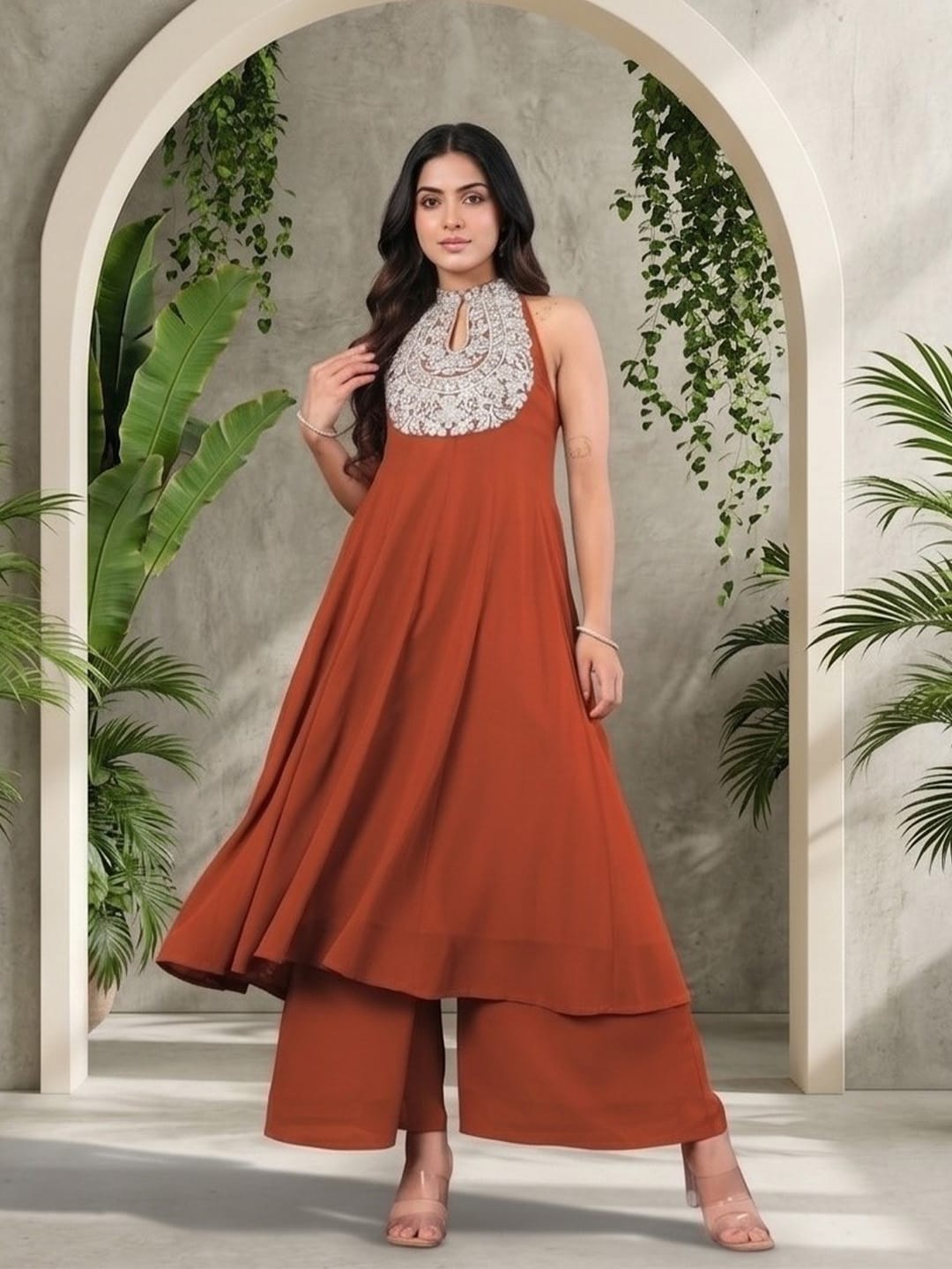 The Kurti Collection Women Rust Yoke Embroidered Sleeveless Flared Kurta With Trousers.