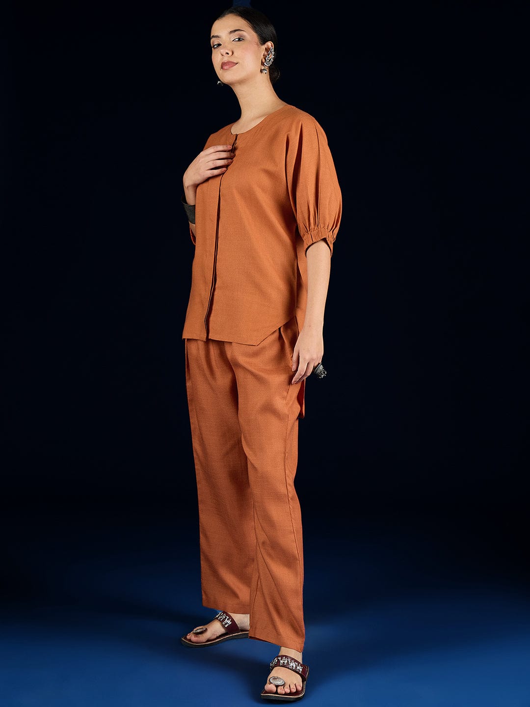 The Kurti Collection Rust Straight-Fit Shirt With Puff Sleeves And A Round Neck, Paired With Solid Ankle-Length Straight-Fit Trousers.
