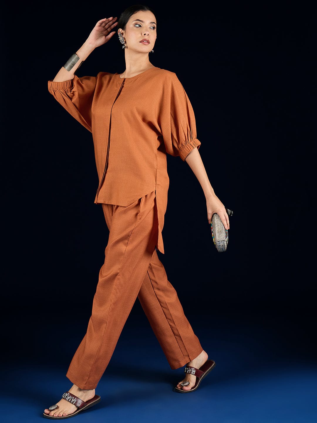The Kurti Collection Rust Straight-Fit Shirt With Puff Sleeves And A Round Neck, Paired With Solid Ankle-Length Straight-Fit Trousers.