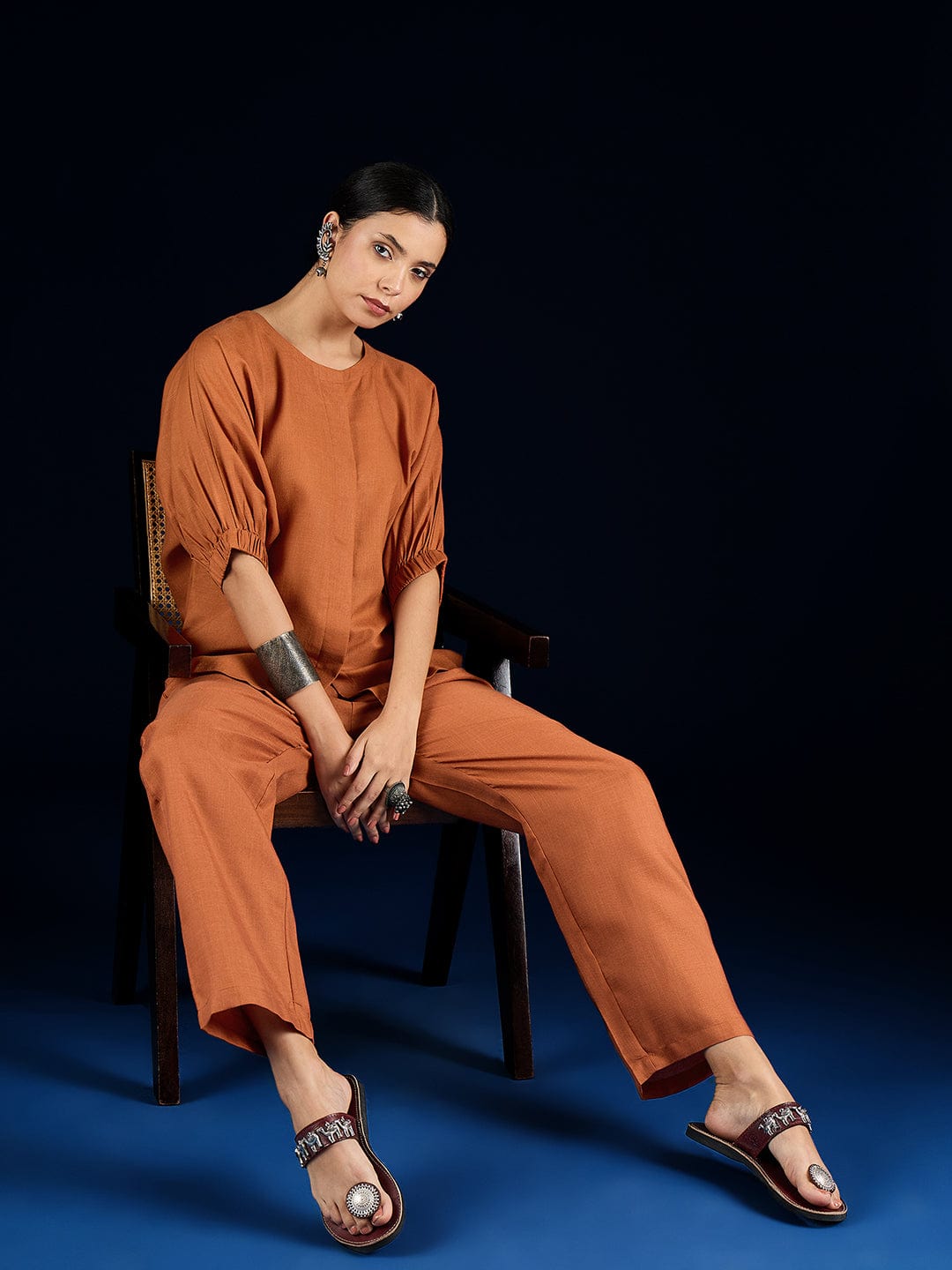 The Kurti Collection Rust Straight-Fit Shirt With Puff Sleeves And A Round Neck, Paired With Solid Ankle-Length Straight-Fit Trousers.