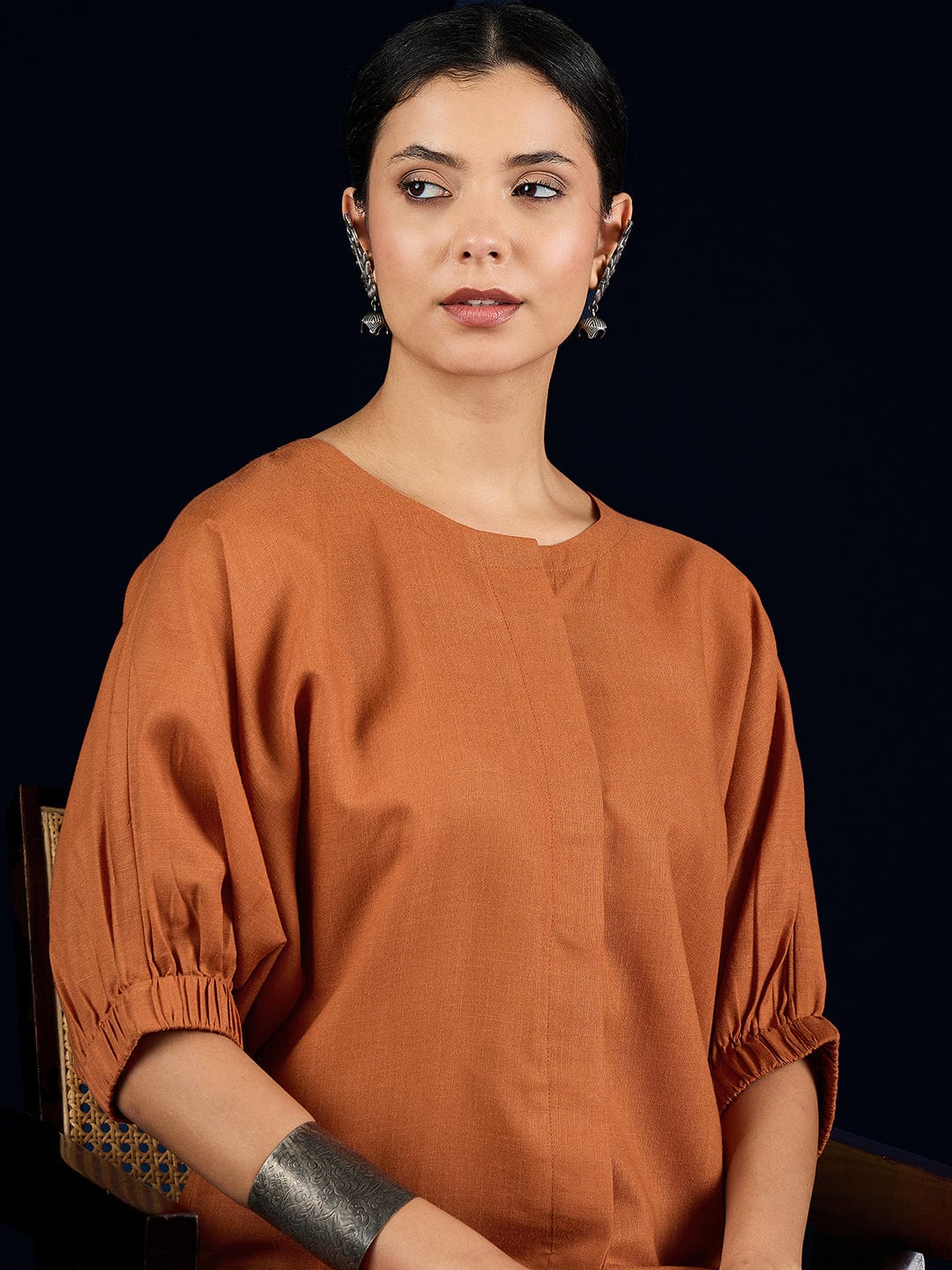 The Kurti Collection Rust Straight-Fit Shirt With Puff Sleeves And A Round Neck, Paired With Solid Ankle-Length Straight-Fit Trousers.
